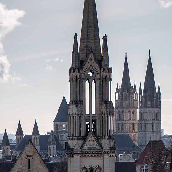spires of Caen Cathedral in France.