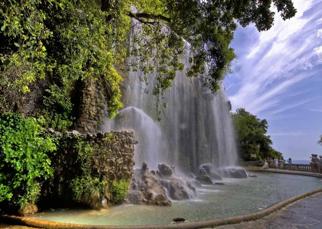 waterfall in castle hill in nice, France. people on guided tour
