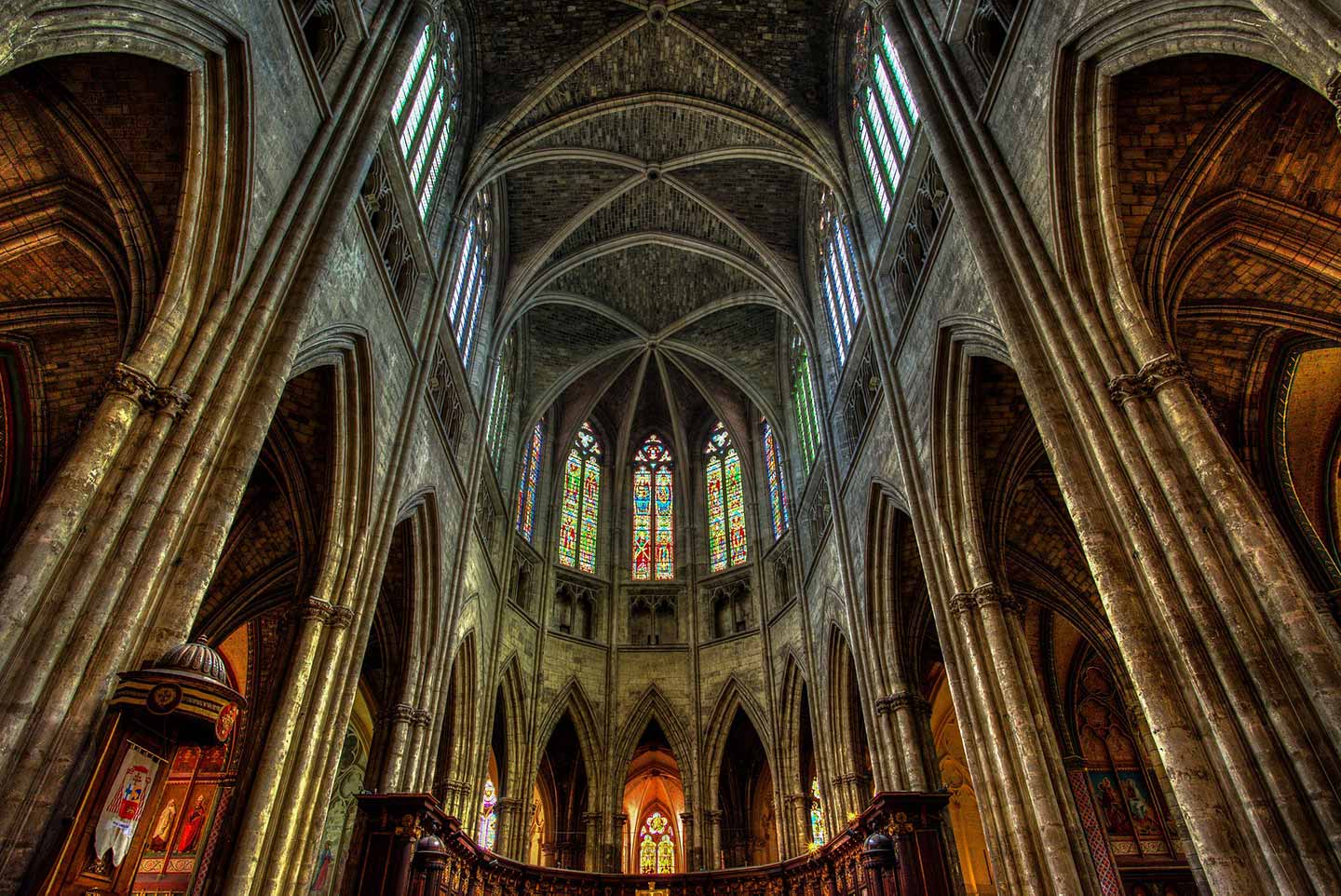 view of stained glass windows in Bordeaux cathedral from the inside