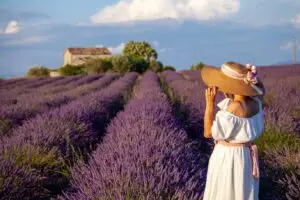 woman standing amongst field of lavendar in France.