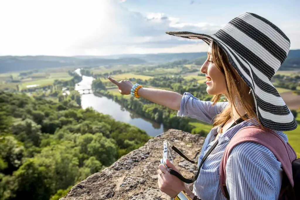 female tourist pointing out the beauty of Dordogne
