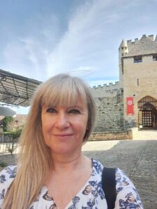 Tour guide Jeanette in front of a historical castle in France during a Luxury France Tour.