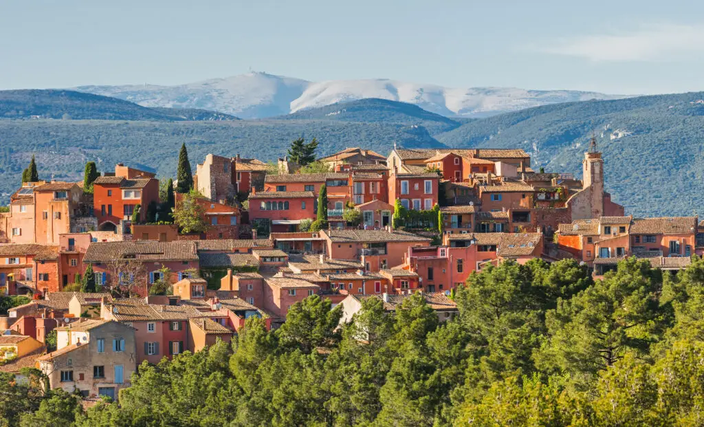 Scenic view of the colorful village of Roussillon with Mount Ventoux in the background, located in the Vaucluse region of Provence, France