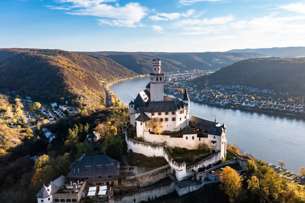 Aerial view of Marksburg Castle on a sunny day, overlooking the Rhine River and the quaint village of Braubach, UNESCO World Heritage Site in the Upper Middle Rhine Valley, Germany
