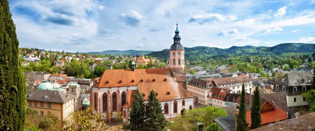 Panoramic view of Baden-Baden showcasing historical architecture and lush green hills, in Germany, Europe