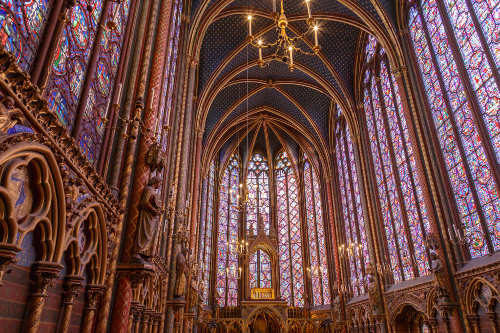 Interior view of the Sainte Chapelle in Paris, showcasing the intricate Gothic architecture and vibrant stained glass windows.