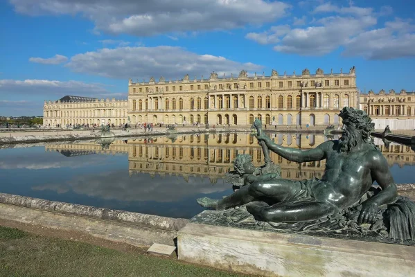 young people posing at statue outside versailles palace
